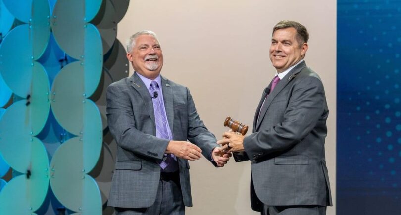 Paul Schuler receives the Water Environment Federation president's gavel from Keith Hobson