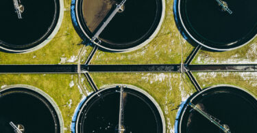 Stock photo titled 'Sewage farm', showing a wastewater treatment site.
