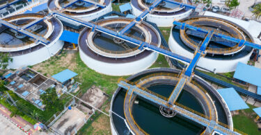 Overhead aerial drone view looking straight down into a clarifier sedimentation tank.