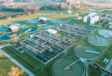 Aerial view of a wastewater treatment plant, showing its layout of structures and basins from above.