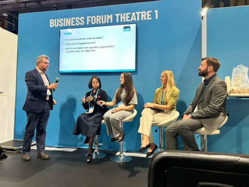 Five CREWW representatives standing at the University of Exeter exhibition stand during the IWA World Water Congress in Glasgow