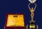 Gold-toned Construction World Global Awards 2026 trophy with diamond-topped figure beside a framed Certificate of Merit for S