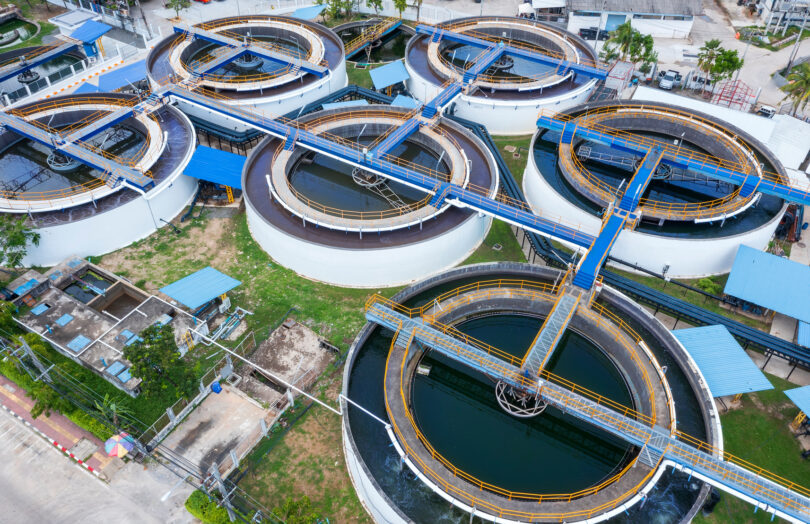 Aerial drone view looking straight down on a circular clarifier sedimentation tank.