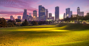 Houston skyline silhouetted against a dawn sky