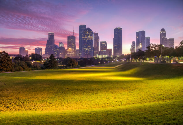 Houston skyline silhouetted against a dawn sky