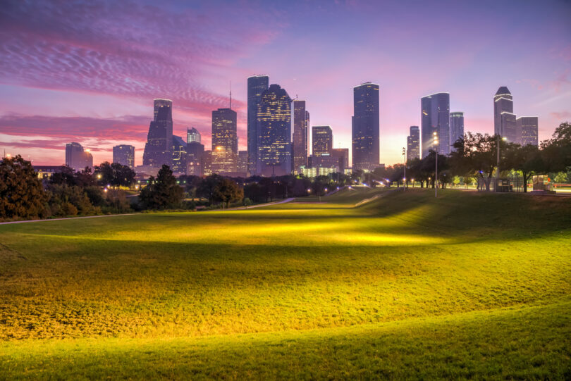 Houston skyline silhouetted against a dawn sky